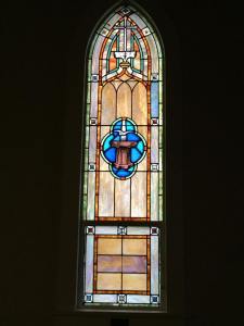A stained glass depiction of the Holy Spirit descending like a dove in baptism at First Lutheran Church in Poulsbo, Washington
