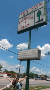 Allison and Amanda in front of the Enchiladas y Mas sign. 